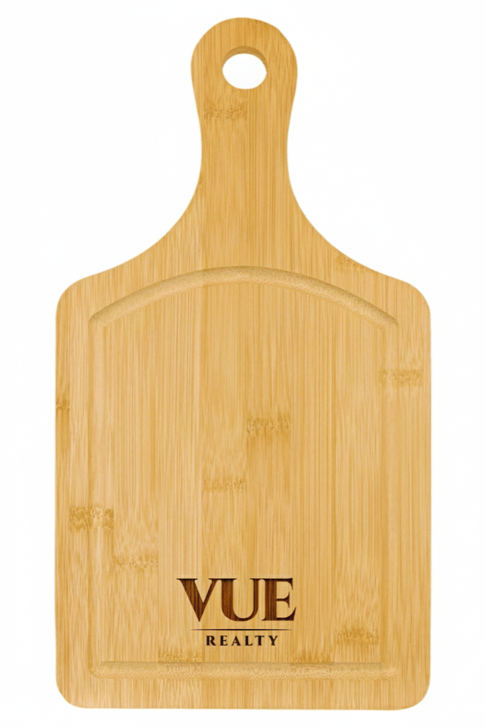 Wooden cutting board with 'VUE REALTY' branding on a white background