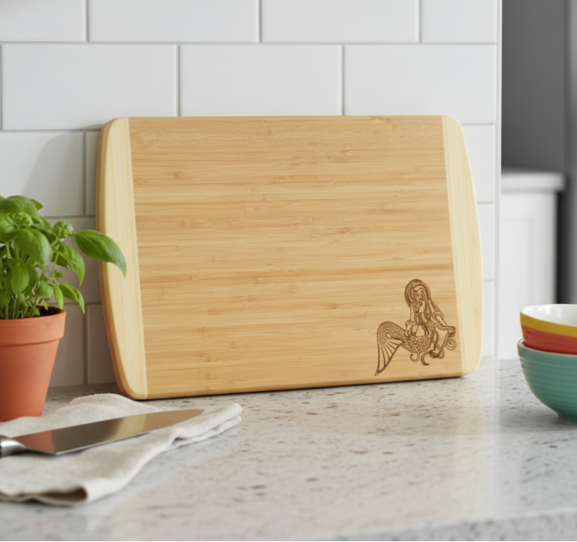 Two Tone Bamboo Cutting Board leaning against a kitchen backsplash