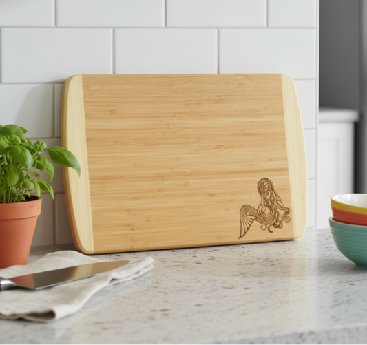 Two Tone Bamboo Cutting Board leaning against a kitchen backsplash