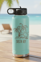 Teal water bottle with palm tree design and 'Siesta Key' text on a wooden surface with a beach background.